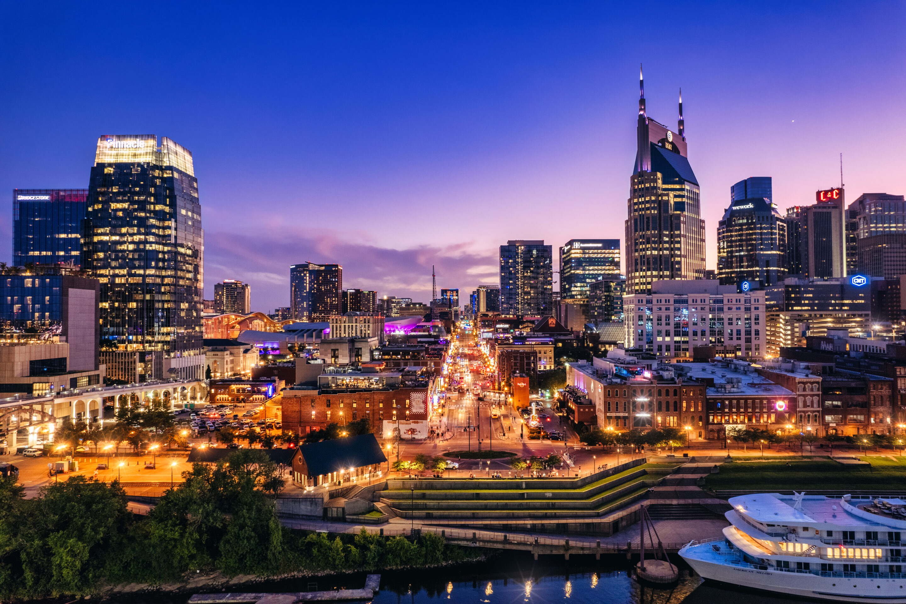 Aerial view of downtown Nashville looking across the Cumberland River and up Broadway at twliight AdobeStock 623604737 scaled